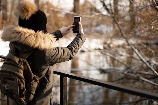 Medium shot traveler taking photos