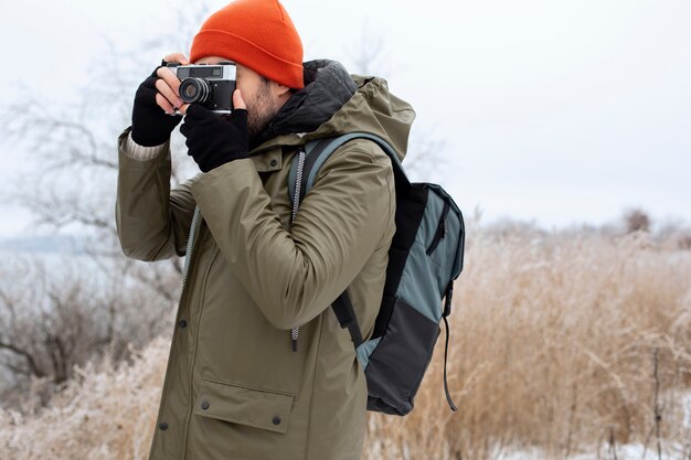 Medium shot traveler taking photos