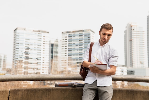 Medium shot of university student with city background