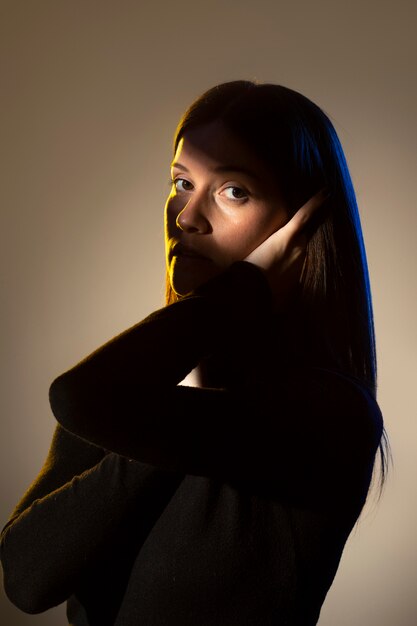 Medium shot unknown young woman posing in studio