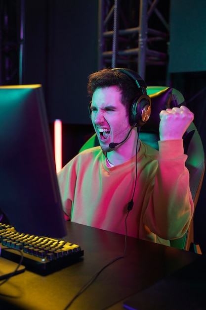 Medium shot victorious gamer at desk