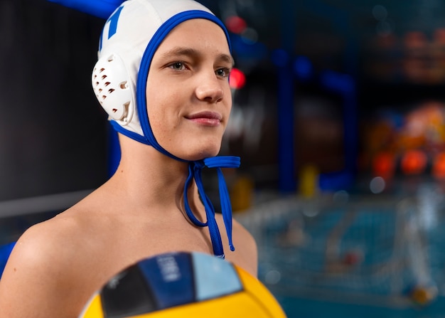 Free photo medium shot waterpolo  player with equipment