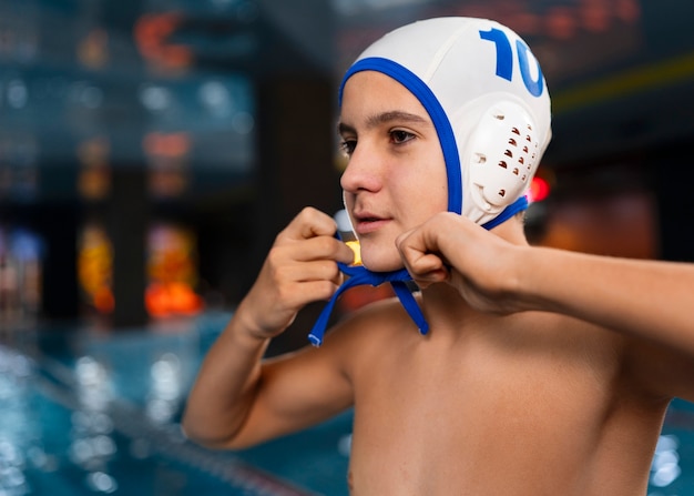 Free photo medium shot waterpolo  player with equipment