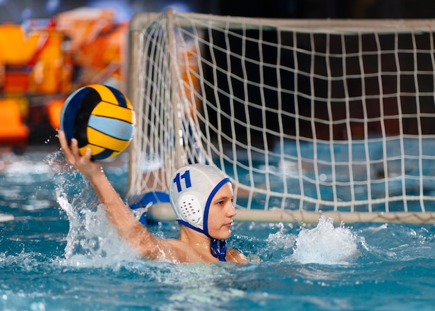 Free photo medium shot waterpolo  player with equipment