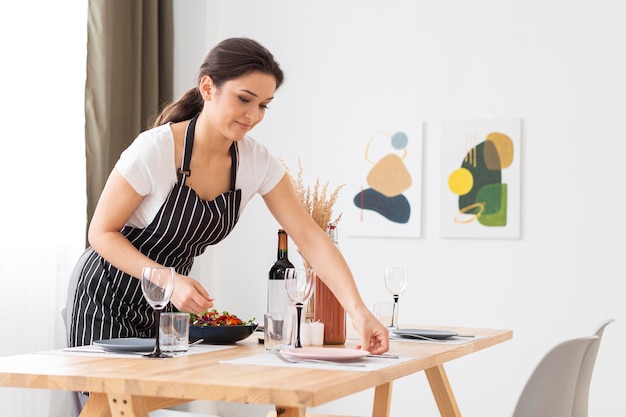 Free photo medium shot woman arranging table