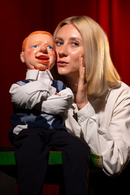 Medium shot woman being ventriloquist