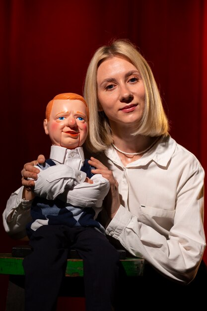 Medium shot woman being ventriloquist