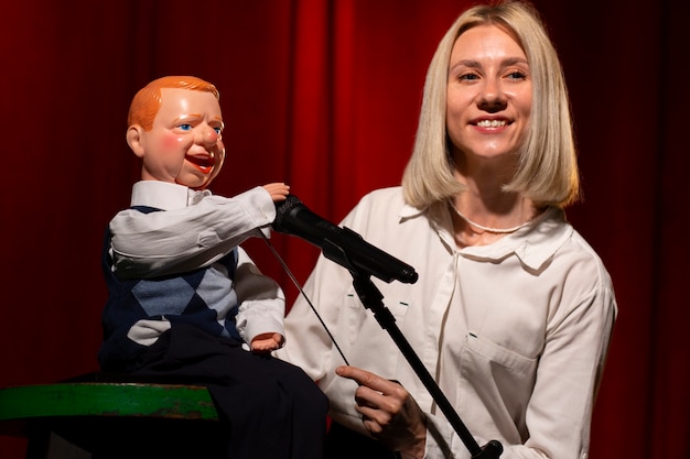 Medium shot woman being ventriloquist