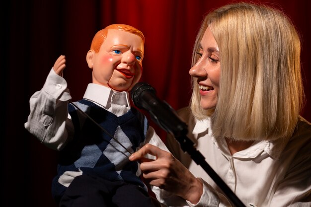 Medium shot woman being ventriloquist