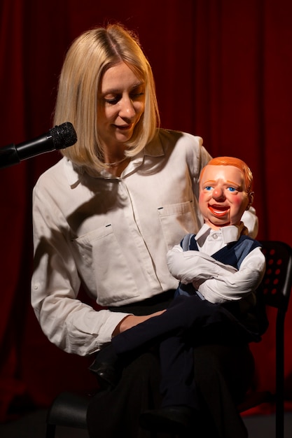 Medium shot woman being ventriloquist