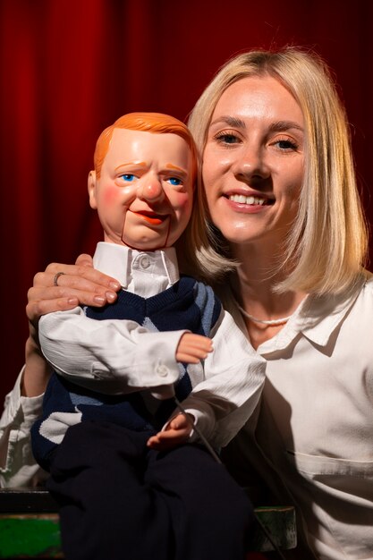 Medium shot woman being ventriloquist
