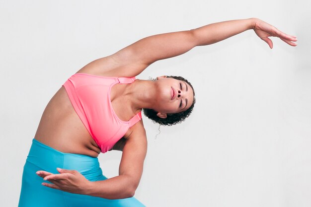 Medium shot woman bending indoors