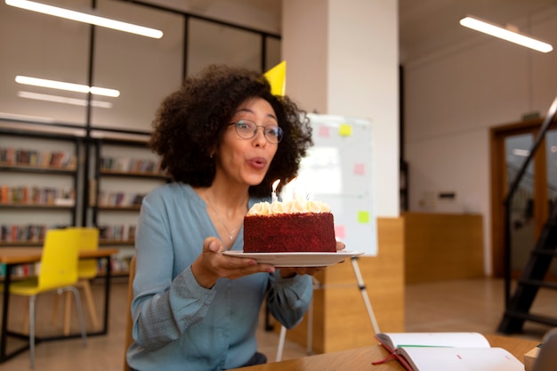 Medium shot woman blowing candles