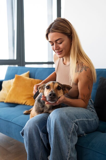 Medium shot woman brushing dog