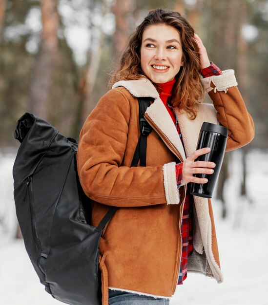 Medium shot  woman carrying backpack