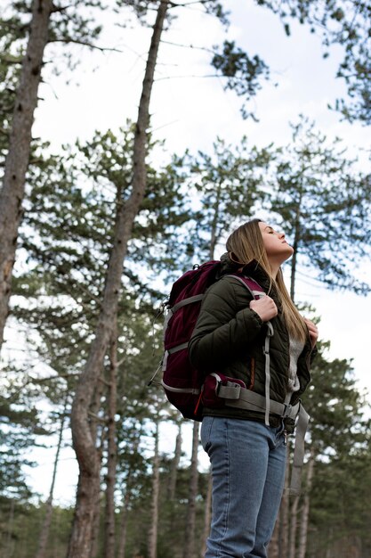 Medium shot woman carrying backpack