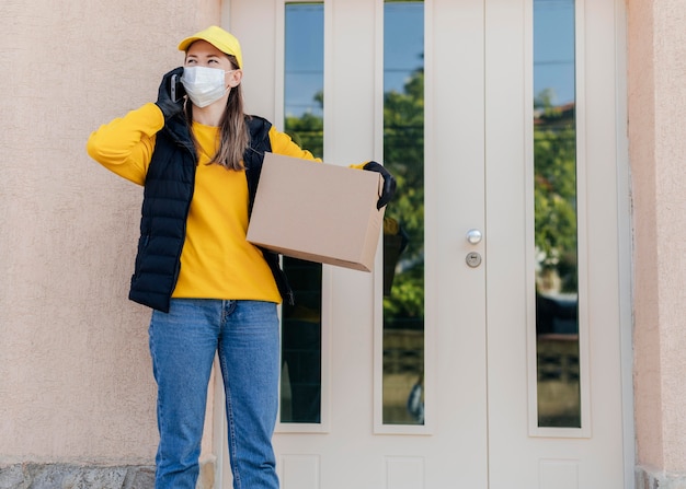 Free photo medium shot woman carrying box