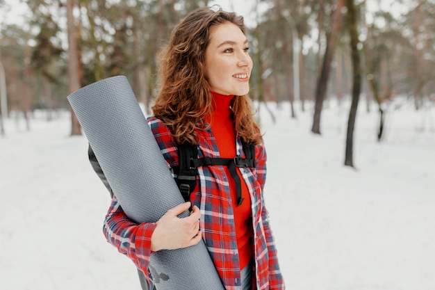 Medium shot woman carrying mat