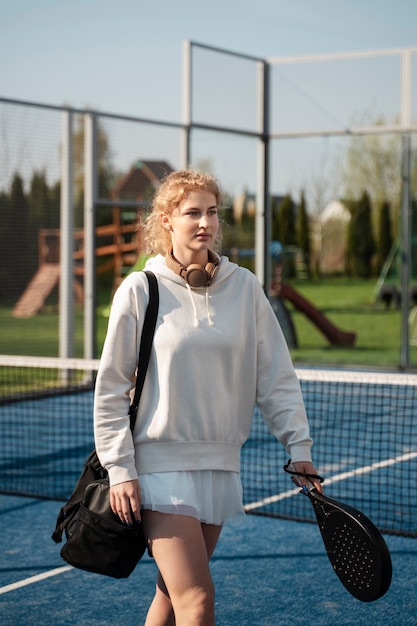 Medium shot woman carrying paddle