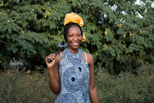 Medium shot woman carrying tool