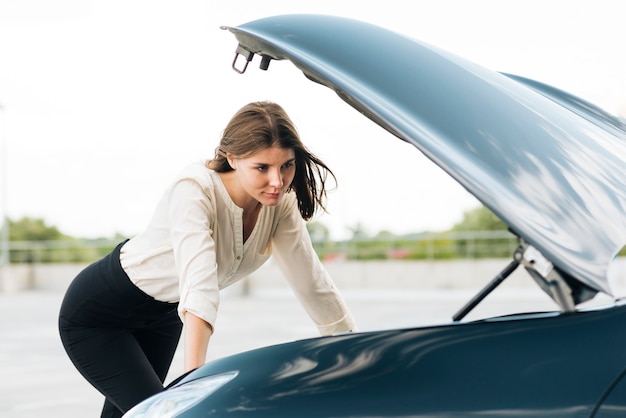 Medium shot of woman checking engine