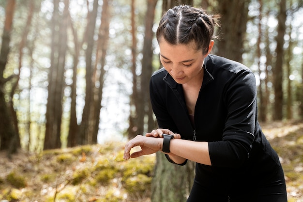 Medium shot woman checking her watch