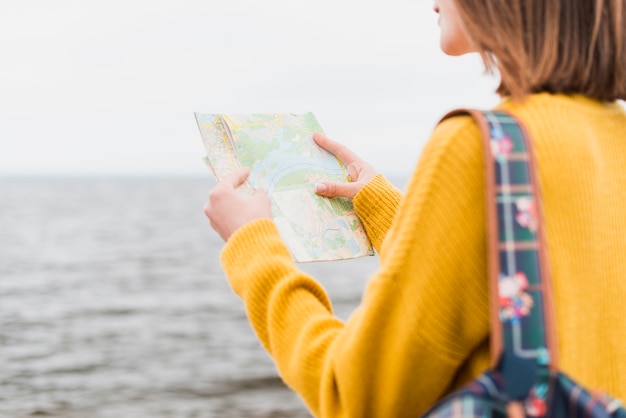 Medium shot of woman checking map