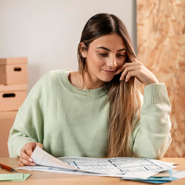 Free photo medium shot woman checking plans