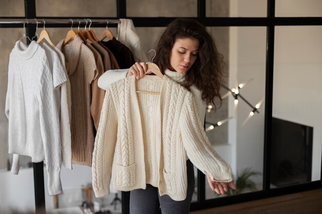 Medium shot woman checking sweater