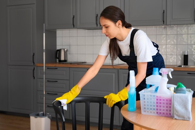 Medium shot woman cleaning home