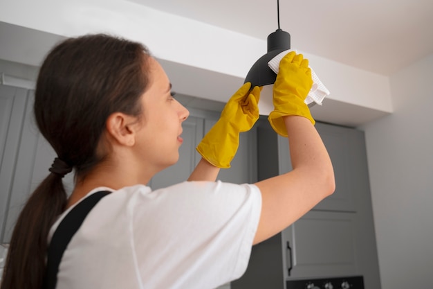 Medium shot woman cleaning home