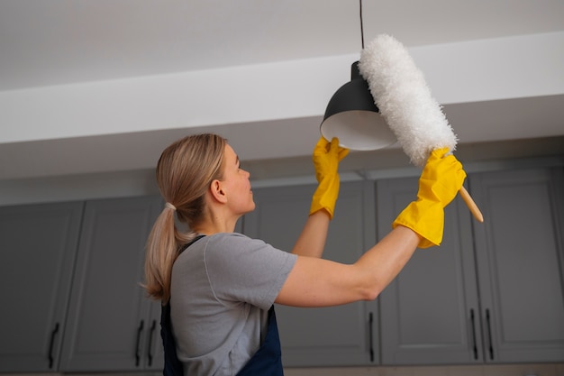 medium shot woman cleaning home