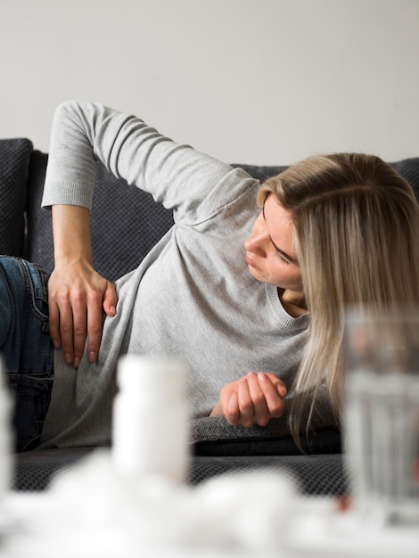 Medium shot woman on couch