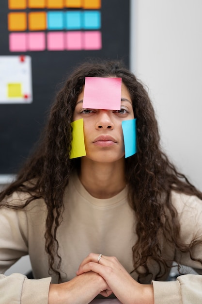 Medium shot woman covered in post its
