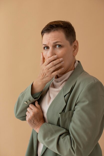 Medium shot woman covering mouth