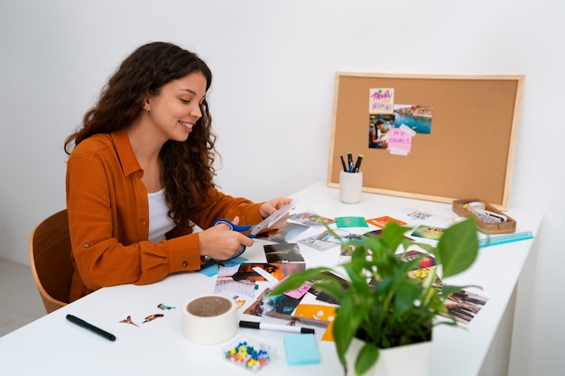 Free photo medium shot woman creating inspiring vision board