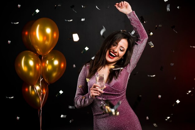 Medium shot of woman dancing at new years party