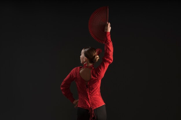 Free photo medium shot woman dancing with fan