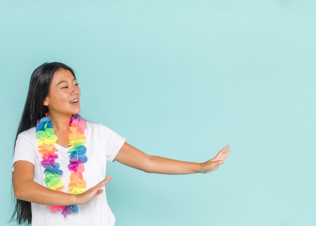 Medium shot of woman dancing with hawaiian flowers