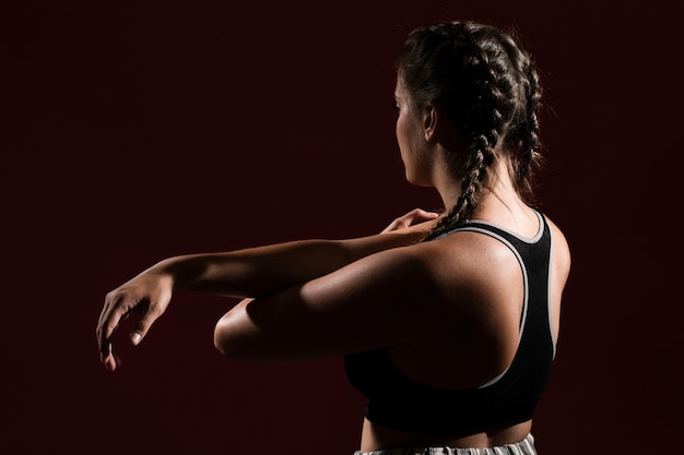 Medium shot woman in dark background from behind shot