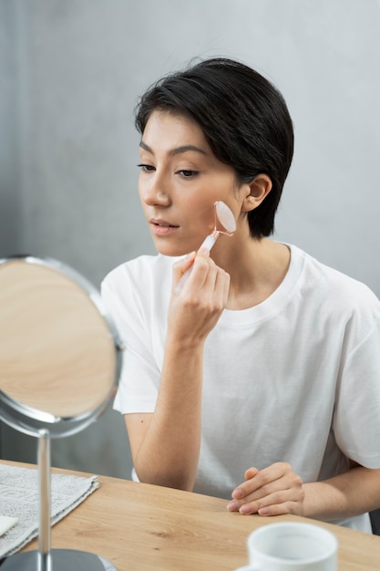 Medium shot woman doing skincare