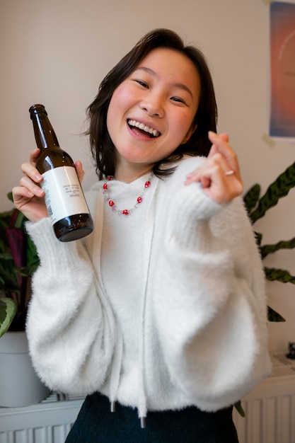 Medium shot woman drinking kombucha