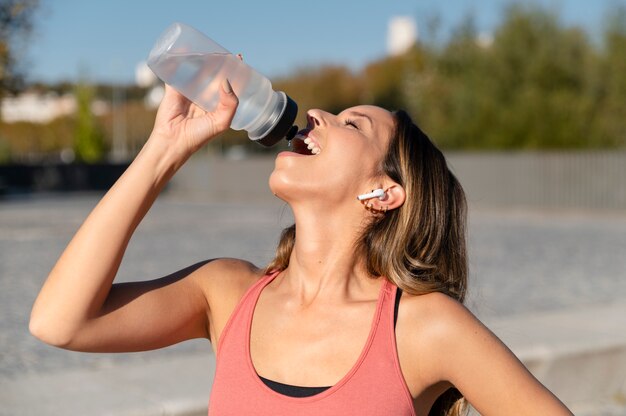 Medium shot woman drinking water