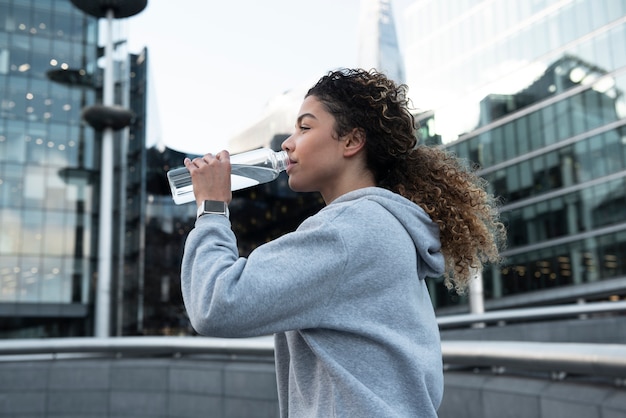 Medium shot woman drinking water