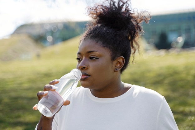Medium shot woman drinking water