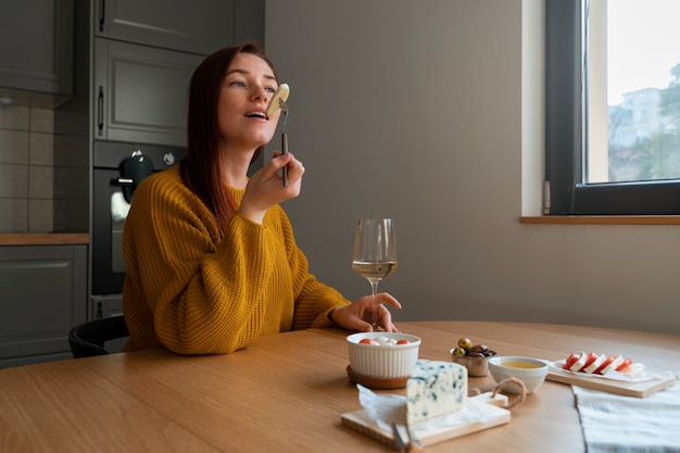 Medium shot woman eating cheese