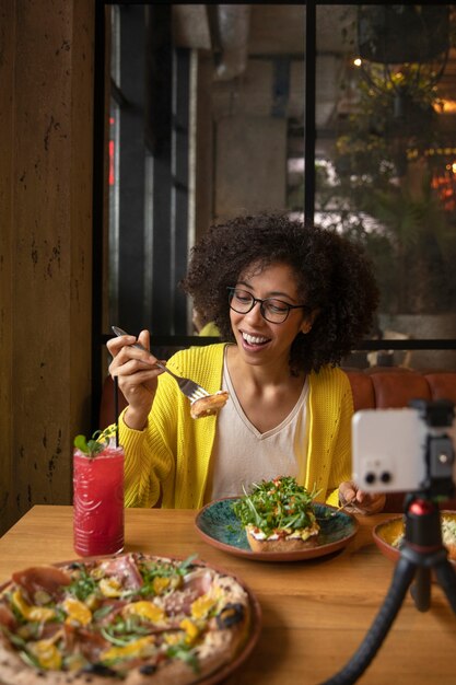 medium shot woman eating delicious food