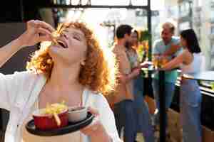 Foto gratuita donna del colpo medio che mangia patatine fritte