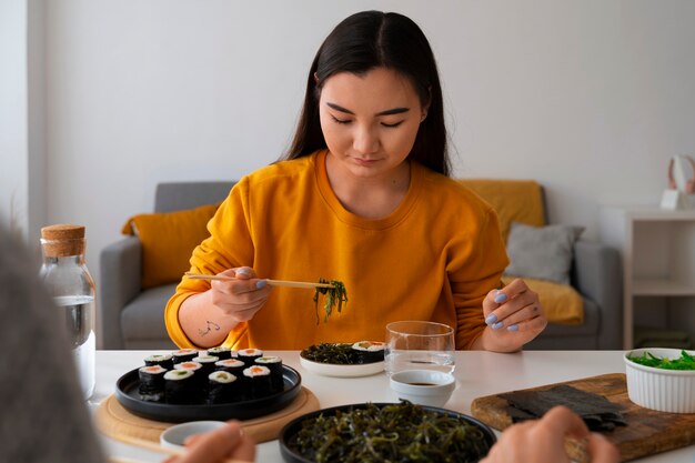 Medium shot woman eating at home