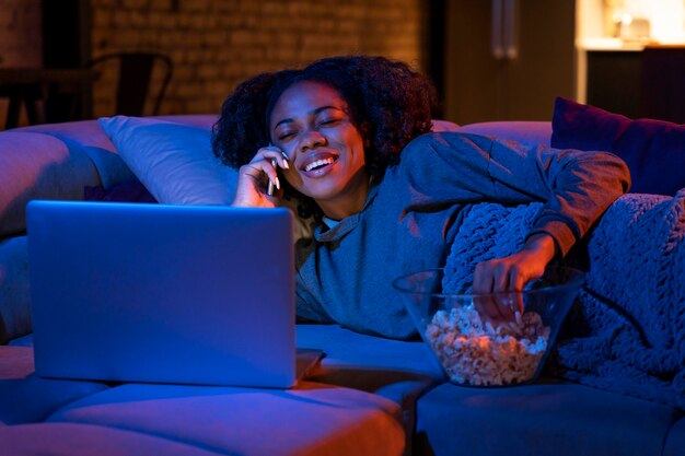 Medium shot woman eating popcorn